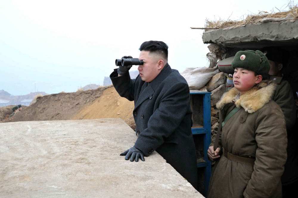 FILE - In this March 7, 2013 file photo released by the Korean Central News Agency (KCNA) and distributed by the Korea News Service, North Korean leader Kim Jong Un uses a pair of binoculars to look at the South's territory from an observation post at the military unit on Jangjae islet, located in the southernmost part of the southwestern sector of North Korea's border with South Korea. For the outside world, North Korea's message is largely doom and gloom: bombastic threats of nuclear war, amateur-looking videos showing U.S. cities in flames, digitally altered photos of military drills. But a domestic audience gets a parallel and decidedly softer dose of propaganda - and one with potentially higher stakes for the country's young leader. (AP Photo/KCNA via KNS, File)